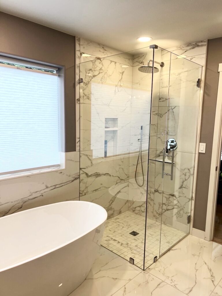 Custom Bath remodel with curb-less shower, large format tile and frameless glass.