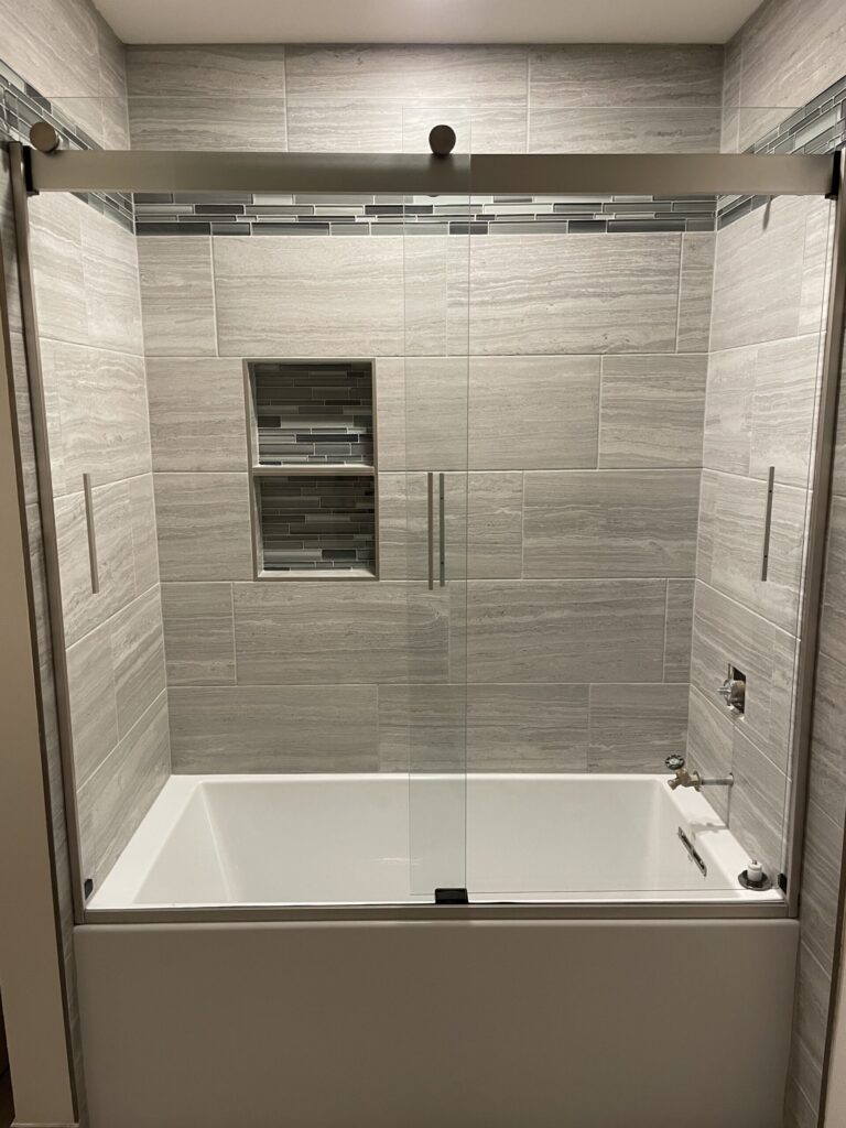 Custom tub surround with niche and tile banner 